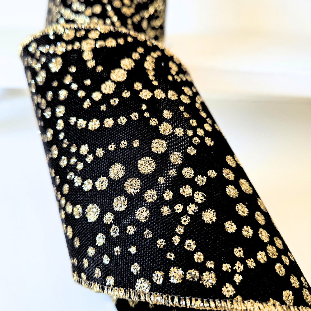 USA imported wired ribbon. 4"Mini Glitter Dots Black/Gold tiny glitter dots in a striking black and gold color scheme. Sold by the meter.