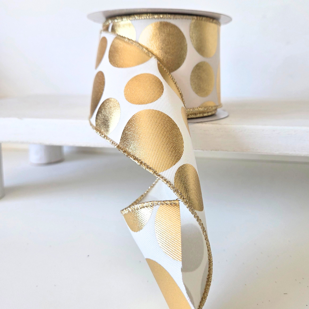 USA imported wired edge ribbon. 2.5" wide, in ivory with metallic gold dots. Sold by the meter.