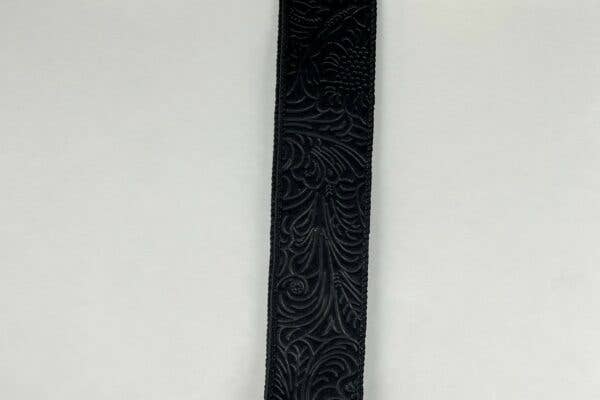 USA imported wired ribbon, 1.5" wide, in black with an embossed flower design. Sold by the meter.