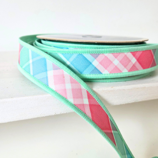High quality premium USA imported wired ribbon.7/8" ribbon in bold plaid pattern in light teal, pink and mint.  Sold by the meter