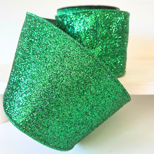 High quality USA imported wired ribbon. 4" wide ribbon in emerald green, made with shimmering laser glitter..  Sold by the meter