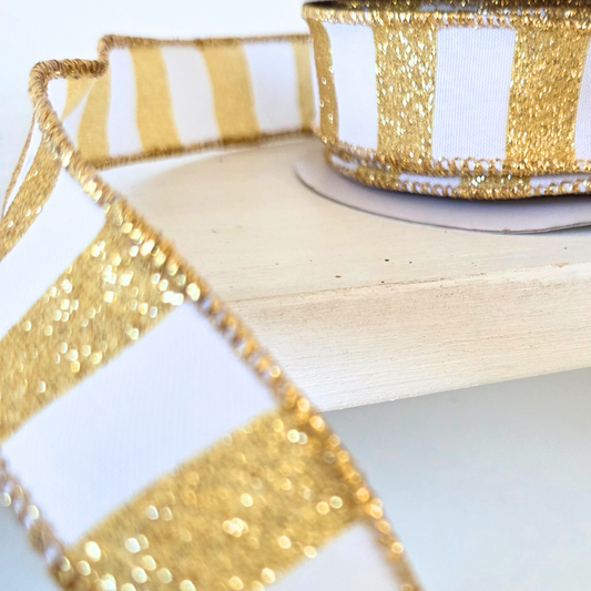 USA imported Wired Ribbon.  Deluxe 1.5" wide Horizontal Glitter Stripes in white and gold.  Sold by the meter