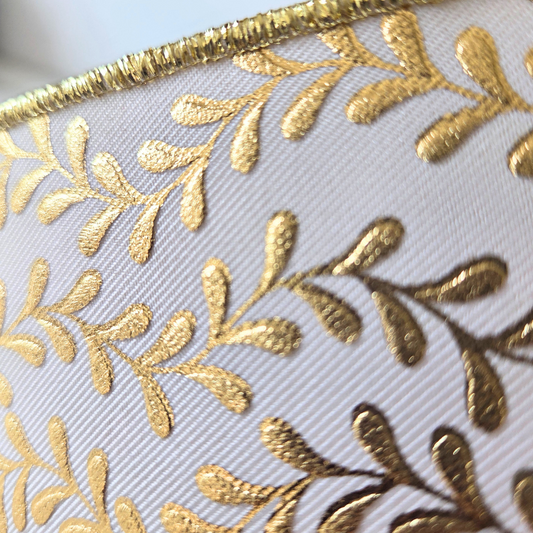 Premium D'Lux 1.5" wide wired ribbon with foil metallic leaf garland design in white and gold.  Sold by the meter