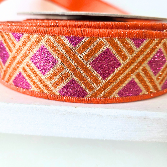 High quality premium USA imported wired ribbon. Deluxe 1.5" wide fused ribbon,with woven stripe design in gold, fuchsia and orange.  Sold per meter