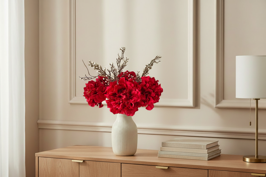 Burgundy and ivory rose arrangement in matching lifestyle setting